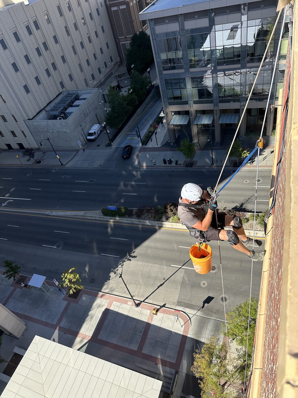 Rope-access technician working on a downtown Utah building
